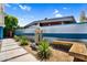 Landscaped backyard featuring a modern water feature, custom corrugated metal fencing and a built-in bench at 1029 E Palo Verde Dr, Phoenix, AZ 85014