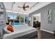 Bright bedroom with a large sliding glass door, wooden floor, and access to a pool at 1029 E Palo Verde Dr, Phoenix, AZ 85014