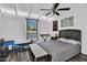Bedroom featuring a large window, ceiling fan, modern decor, and wooden floor at 1029 E Palo Verde Dr, Phoenix, AZ 85014