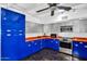 Modern kitchen with sleek blue cabinets, stainless steel appliances, and a functional layout at 1029 E Palo Verde Dr, Phoenix, AZ 85014