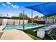 Resort-style pool features waterfall with a statue, covered lounge chairs, and lush landscaping at 1029 E Palo Verde Dr, Phoenix, AZ 85014