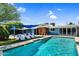 A refreshing pool surrounded by lounge chairs and lush landscaping enhances the backyard at 1029 E Palo Verde Dr, Phoenix, AZ 85014