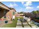 Inviting backyard featuring an outdoor dining area, artificial grass, and landscaped accents at 1101 W Oleander Ave, Queen Creek, AZ 85140
