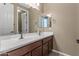 Bathroom featuring a double vanity with two sinks and a large mirror at 1101 W Oleander Ave, Queen Creek, AZ 85140