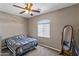Bedroom with ceiling fan, bed, window, wall art, and standing mirror at 1101 W Oleander Ave, Queen Creek, AZ 85140