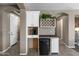 A Coffee Bar featuring white cabinetry, dark countertops, a mini-fridge and ample lighting at 1101 W Oleander Ave, Queen Creek, AZ 85140