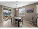 Cozy dining area features a modern table, chairs and a large sliding door to outside patio at 1101 W Oleander Ave, Queen Creek, AZ 85140
