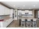 Bright kitchen featuring white cabinetry, granite countertops, and stainless steel appliances at 1101 W Oleander Ave, Queen Creek, AZ 85140