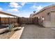 A side yard featuring a brick paved driveway and wooden fence with an agave plant at 1101 W Oleander Ave, Queen Creek, AZ 85140