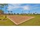 Community sand volleyball court surrounded by lush green lawns and shade trees at 1101 W Oleander Ave, Queen Creek, AZ 85140