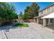 Expansive backyard featuring a large patio, artificial turf, mature trees, and a gazebo offers space for outdoor living at 12546 N 142Nd Ln, Surprise, AZ 85379