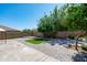 Landscaped backyard with artificial turf, mature trees, patio and privacy wall at 12546 N 142Nd Ln, Surprise, AZ 85379