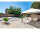 Backyard featuring a gazebo, artificial turf, mature trees, and brick pavers at 12546 N 142Nd Ln, Surprise, AZ 85379