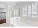 Modern bathroom featuring white finishes, a large bathtub, and glass-enclosed shower at 12546 N 142Nd Ln, Surprise, AZ 85379