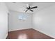 Bedroom with wood floors, light paint, and a window with white shutters at 12546 N 142Nd Ln, Surprise, AZ 85379