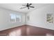 Bedroom with hard wood flooring and a window with wood shutters at 12546 N 142Nd Ln, Surprise, AZ 85379