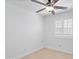 Bright bedroom with neutral walls, ceiling fan, and shuttered window at 12546 N 142Nd Ln, Surprise, AZ 85379