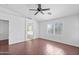 Spacious bedroom featuring hardwood floors, bright light, and an ensuite bathroom at 12546 N 142Nd Ln, Surprise, AZ 85379