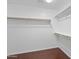 A walk-in closet providing ample storage with shelving and wood floors at 12546 N 142Nd Ln, Surprise, AZ 85379