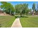 Picturesque community path winding through lush green spaces, offering a serene and inviting atmosphere at 12546 N 142Nd Ln, Surprise, AZ 85379