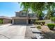 Charming two-story home showcasing a well-manicured lawn, complemented by a paved walkway and a spacious two-car garage at 12546 N 142Nd Ln, Surprise, AZ 85379