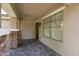 Welcoming covered front porch featuring elegant stone accents, tiled flooring, and a stylish front door at 12546 N 142Nd Ln, Surprise, AZ 85379