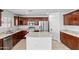 Spacious kitchen with stainless steel appliances, granite countertops and island at 12546 N 142Nd Ln, Surprise, AZ 85379