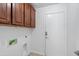 Clean laundry room with ample upper cabinet storage at 12546 N 142Nd Ln, Surprise, AZ 85379