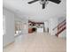 Open-concept living room view to kitchen with stainless appliances and neutral tile flooring at 12546 N 142Nd Ln, Surprise, AZ 85379