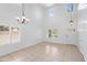 Bright living room featuring soaring ceilings, neutral tile flooring, and an abundance of natural light from shuttered windows at 12546 N 142Nd Ln, Surprise, AZ 85379
