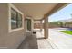 Covered patio with views of the backyard, and access to the home through sliding glass doors at 12546 N 142Nd Ln, Surprise, AZ 85379