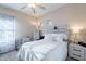 Comfortable bedroom with a cozy bed, side tables, a ceiling fan, and a desk area at 13318 W Indianola Ave, Litchfield Park, AZ 85340