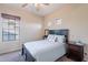 Bedroom with a large window letting in natural light and decorated with charming personal touches at 13318 W Indianola Ave, Litchfield Park, AZ 85340