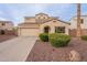Charming two-story home featuring a two-car garage, well-maintained landscaping, and a red-tile roof at 13318 W Indianola Ave, Litchfield Park, AZ 85340