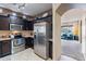 Well-equipped kitchen featuring stainless steel appliances, granite countertops, and open view to living area at 13318 W Indianola Ave, Litchfield Park, AZ 85340