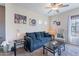 Cozy living room with comfortable seating, modern decor, and natural light from the window at 13318 W Indianola Ave, Litchfield Park, AZ 85340