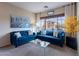 Bright living room with comfortable seating, large windows, modern decor, and lots of natural light at 13318 W Indianola Ave, Litchfield Park, AZ 85340