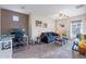 Stylish living room featuring a desk, plush sofa, modern decor, and a ceiling fan at 13318 W Indianola Ave, Litchfield Park, AZ 85340