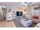Open living room design features a large television, comfortable furniture, and a ceiling fan at 13318 W Indianola Ave, Litchfield Park, AZ 85340