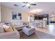 Bright, open-concept living space with comfortable seating, stylish decor, and seamless flow to kitchen at 13318 W Indianola Ave, Litchfield Park, AZ 85340