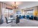 Open floor plan with living and dining areas, large windows, stylish furniture, and bright, natural light at 13318 W Indianola Ave, Litchfield Park, AZ 85340