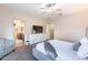 Spacious bedroom features a TV console, a comfortable bed, and a view into the en suite bathroom at 13318 W Indianola Ave, Litchfield Park, AZ 85340