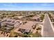 This aerial view showcases the home's backyard landscaping and desert landscaping in the neighborhood at 1415 N Frederick Ln, Casa Grande, AZ 85122