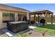 Beautiful backyard with a covered patio, hot tub, desert landscaping, and an inviting outdoor space at 1415 N Frederick Ln, Casa Grande, AZ 85122