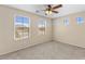 Bedroom with carpeted floor, ceiling fan, and large windows for natural light at 1415 N Frederick Ln, Casa Grande, AZ 85122