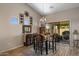 Bright dining area with hardwood floors, stylish chandelier, and convenient access to the backyard at 1415 N Frederick Ln, Casa Grande, AZ 85122