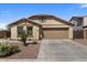 Inviting single-story home displaying desert landscaping, neutral colors, and a wide driveway at 1415 N Frederick Ln, Casa Grande, AZ 85122