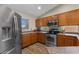 Updated kitchen with stainless steel appliances and wood-look flooring at 1415 N Frederick Ln, Casa Grande, AZ 85122