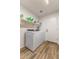 Spacious laundry room with full-size washer and dryer and wood-look flooring at 1415 N Frederick Ln, Casa Grande, AZ 85122