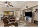 Cozy living room boasting plush seating, wood-look flooring, and a decorative fireplace with TV at 1415 N Frederick Ln, Casa Grande, AZ 85122